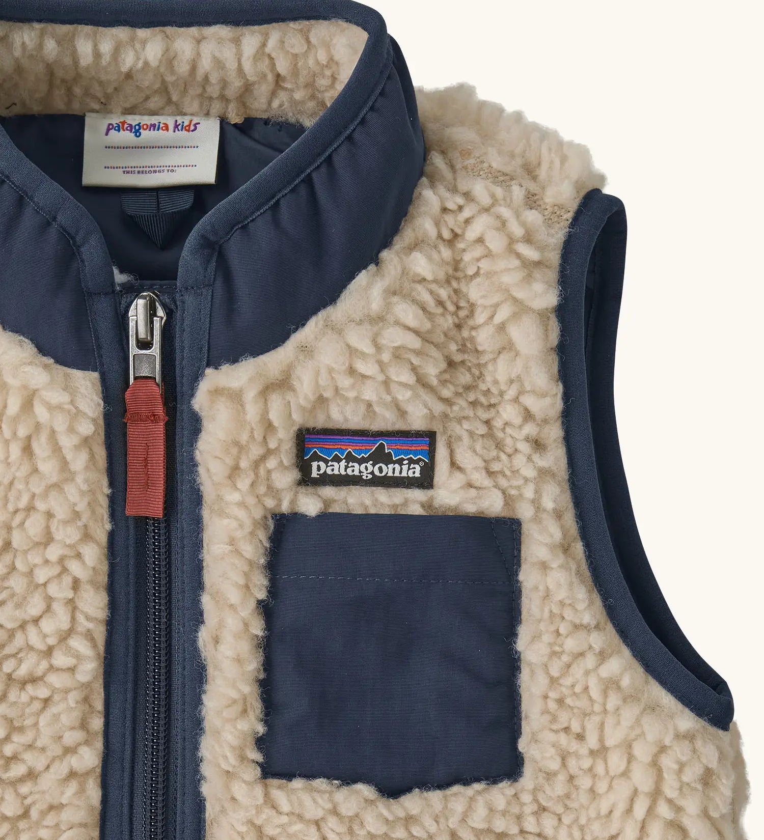 Patagonia 100% recycled polyester little kids retro x high pile fleece vest in beige   showing close up of the navy turned up collar and chest pocket