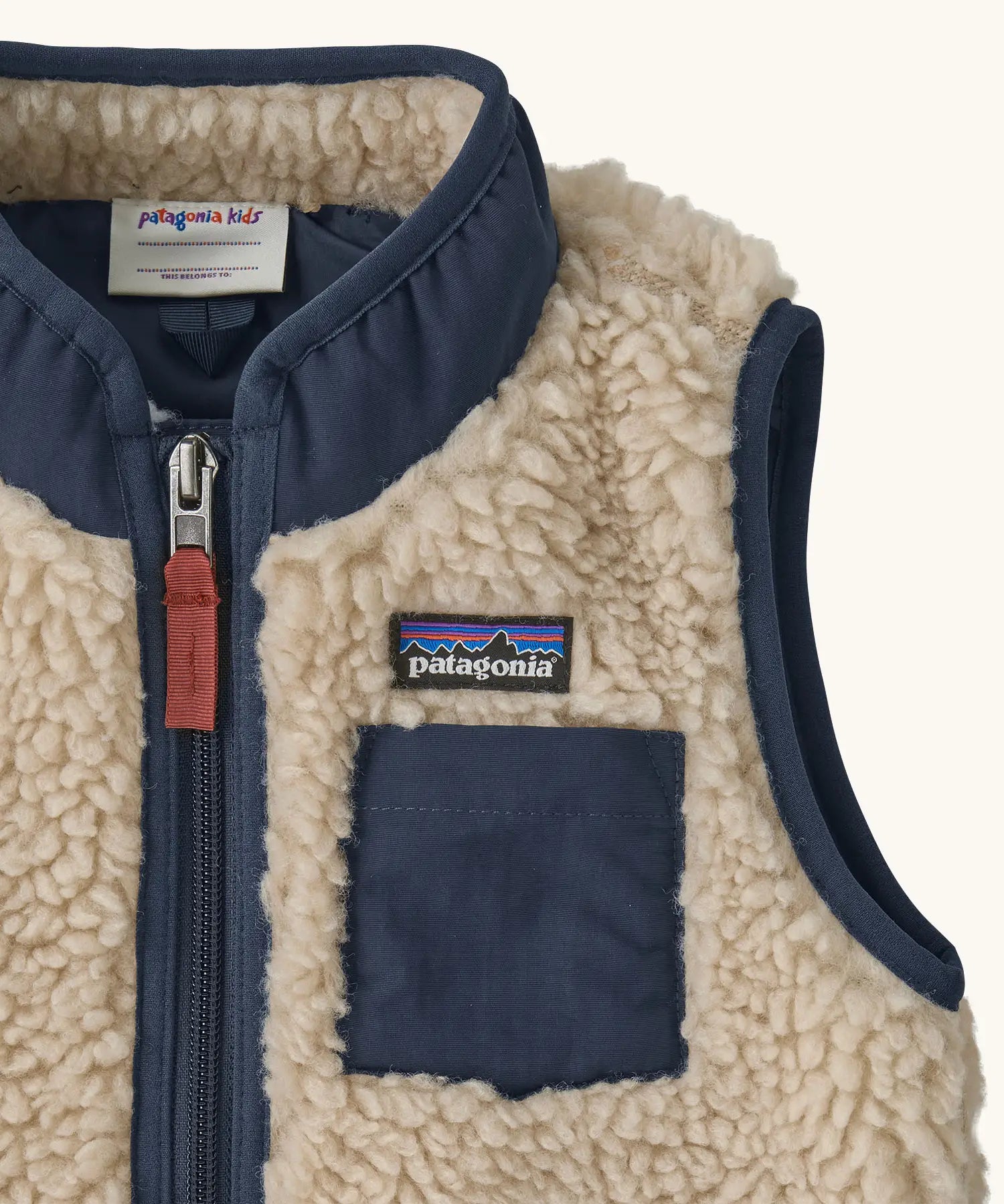 Patagonia 100% recycled polyester little kids retro x high pile fleece vest in beige   showing close up of the navy turned up collar and chest pocket