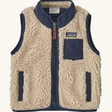 Patagonia 100% recycled polyester little kids retro x high pile fleece vest in beige   with navy trim. Features a full length zip, side and chest pockets 