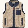 Patagonia 100% recycled polyester little kids retro x high pile fleece vest in beige   with navy trim. Features a full length zip, side and chest pockets 