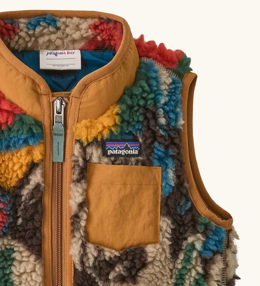 Patagonia 100% recycled polyester little kids retro x high pile fleece vest with abstract design showing close up of brown chest pocket and turn up collar