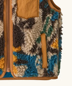Patagonia 100% recycled polyester little kids retro x high pile fleece vest with abstract design showing close up the side pocket with brown trim