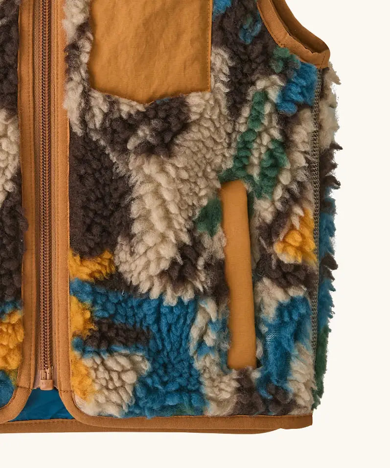 Patagonia 100% recycled polyester little kids retro x high pile fleece vest with abstract design showing close up the side pocket with brown trim