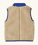 Back of Patagonia's little kids retro x high pile fleece vest in beige showing coloured hem trim and stand up collar