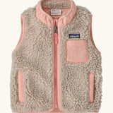 Patagonia 100% recycled polyester little kids retro x high pile fleece vest in beige   with pink trim. Features a full length zip, side and chest pockets 
