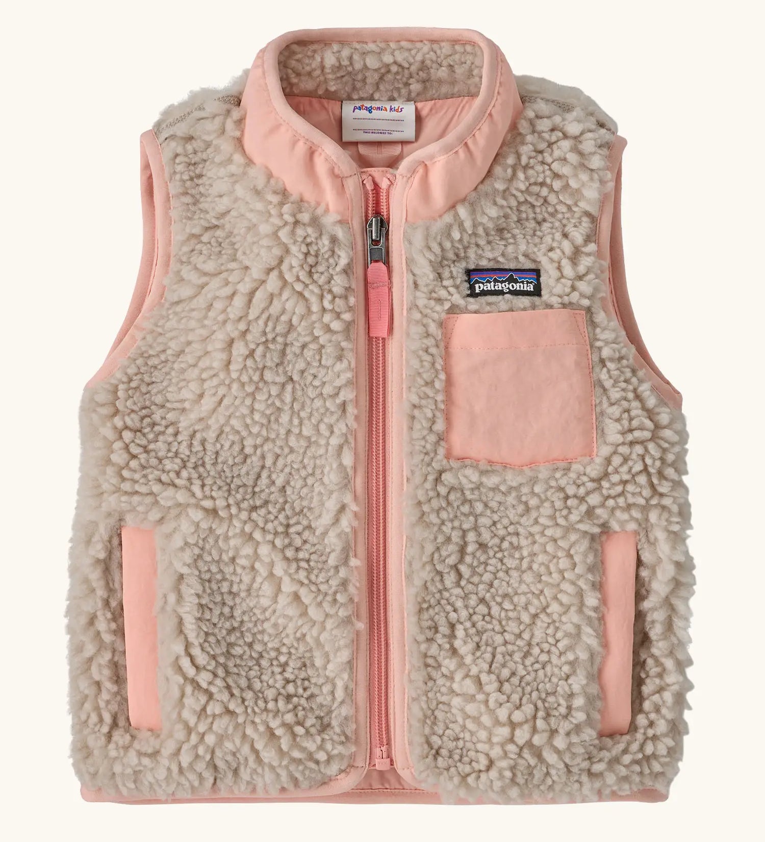 Patagonia 100% recycled polyester little kids retro x high pile fleece vest in beige   with pink trim. Features a full length zip, side and chest pockets 