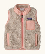 Patagonia 100% recycled polyester little kids retro x high pile fleece vest in beige   with pink trim. Features a full length zip, side and chest pockets 