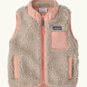 Patagonia 100% recycled polyester little kids retro x high pile fleece vest in beige   with pink trim. Features a full length zip, side and chest pockets 