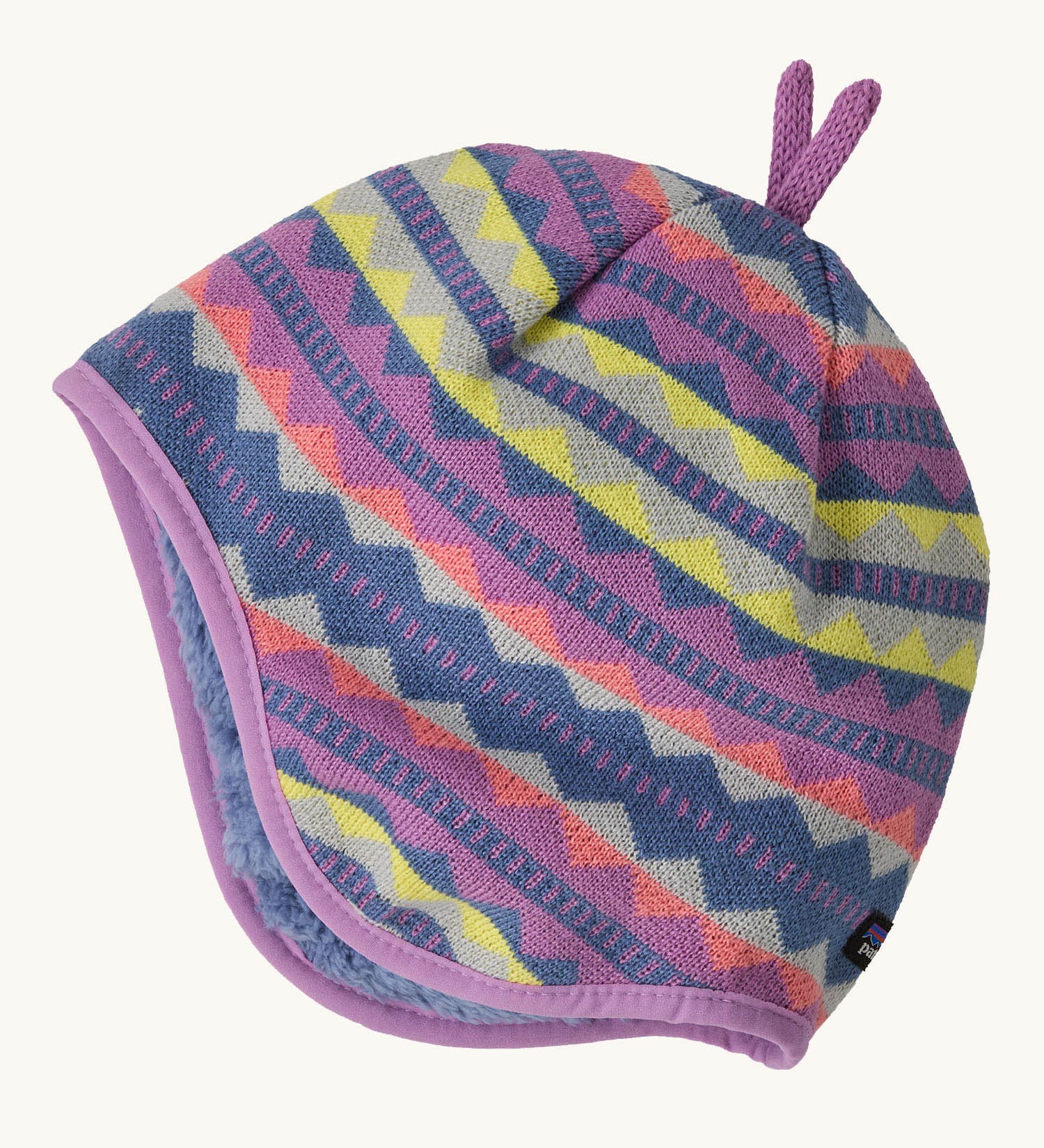 Patagonia little kids in diamond stripe/brisk purple design available at Babipur. A reversible hat which features a purple beanie with different coloured diamonds with purple decorative tabs on top and matching fur on the inside to keep the head and ears warm. 