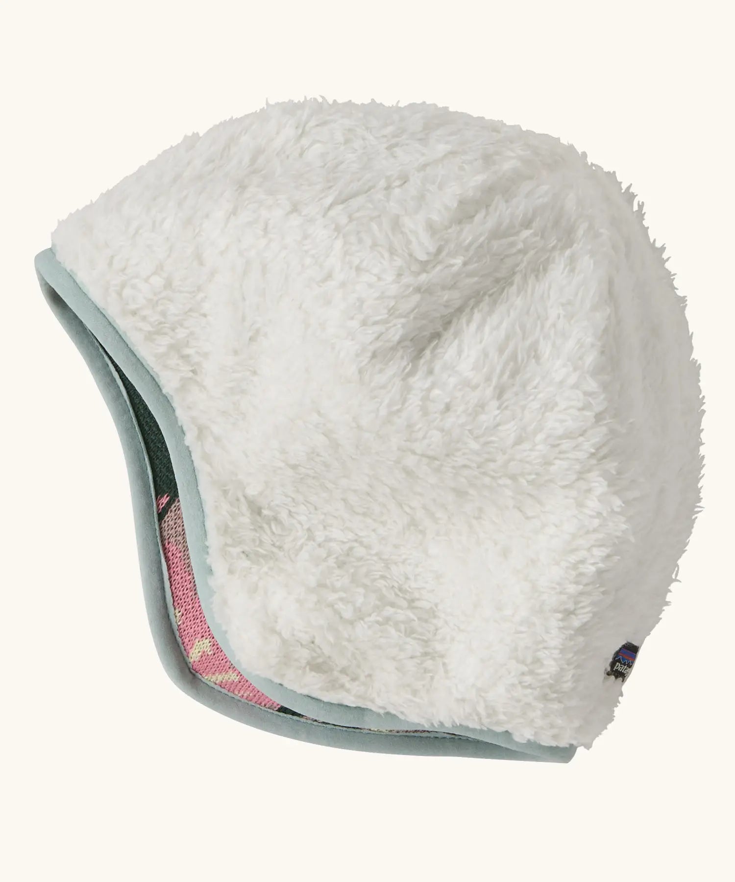 Patagonia recycled polyester baby cosy reversible beanie hat in hope blooms/fuzzy mauve showing a white fleece pile 