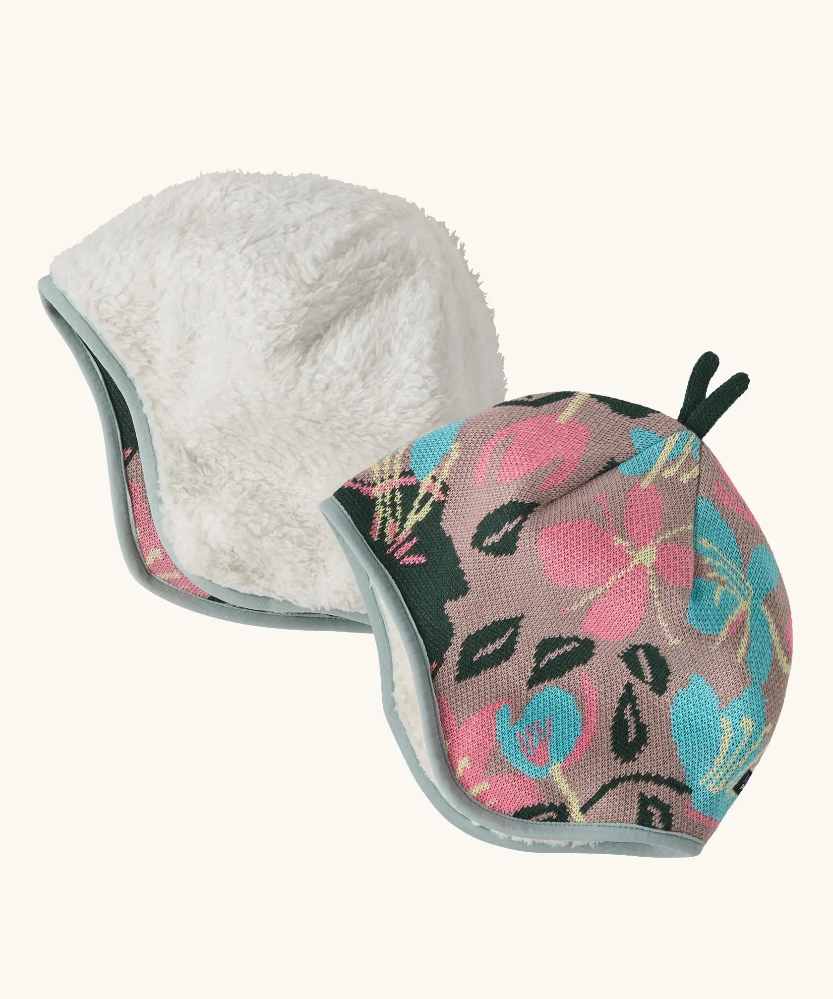 Patagonia baby cosy reversible beanie hat in hope blooms/fuzzy mauve showing a repeating knitted floral design and fleece pile 
