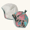 Patagonia baby cosy reversible beanie hat in hope blooms/fuzzy mauve showing a repeating knitted floral design and fleece pile 