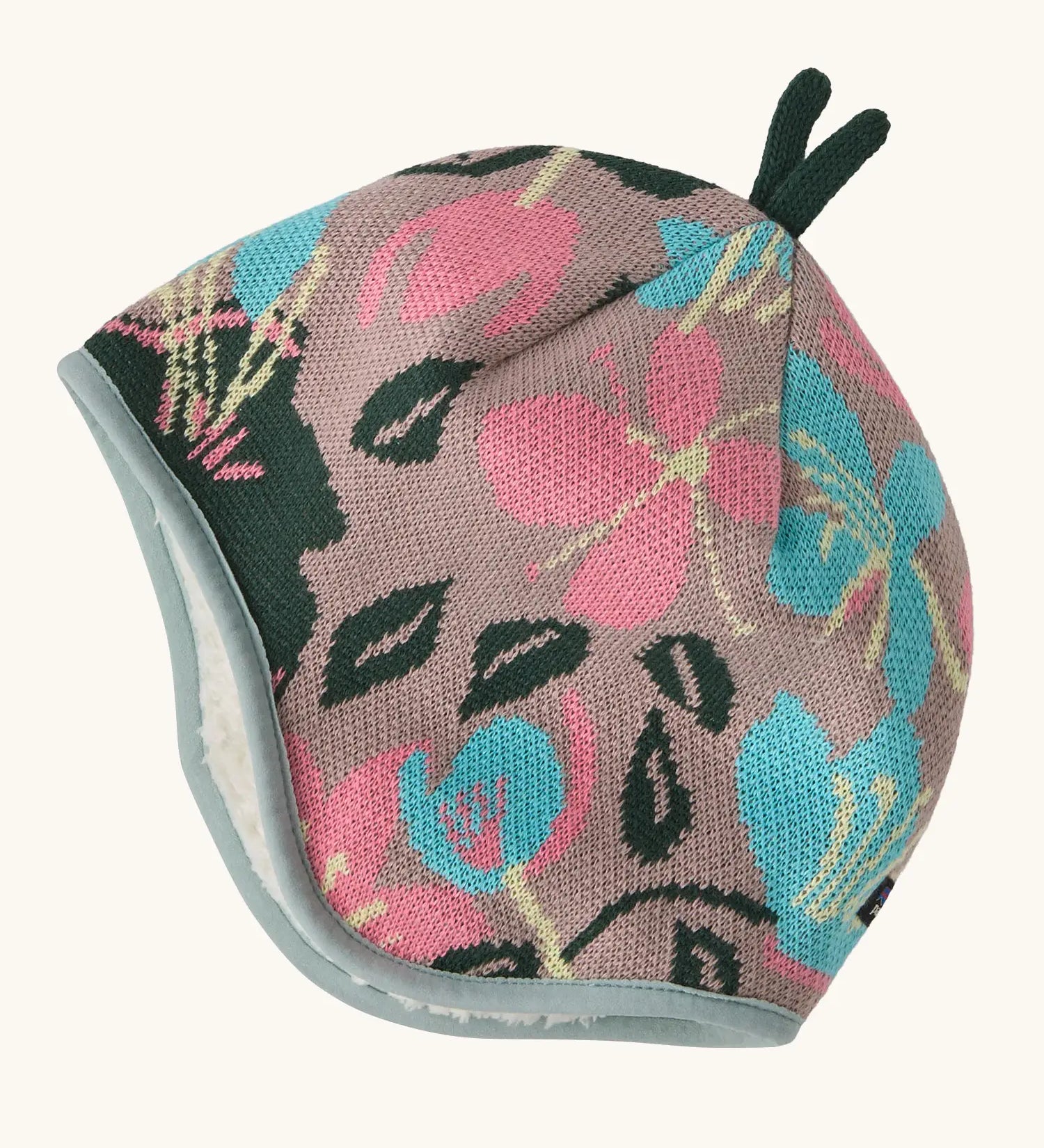 Patagonia baby cosy reversible beanie hat in hope blooms/fuzzy mauve showing a repeating knitted floral design 