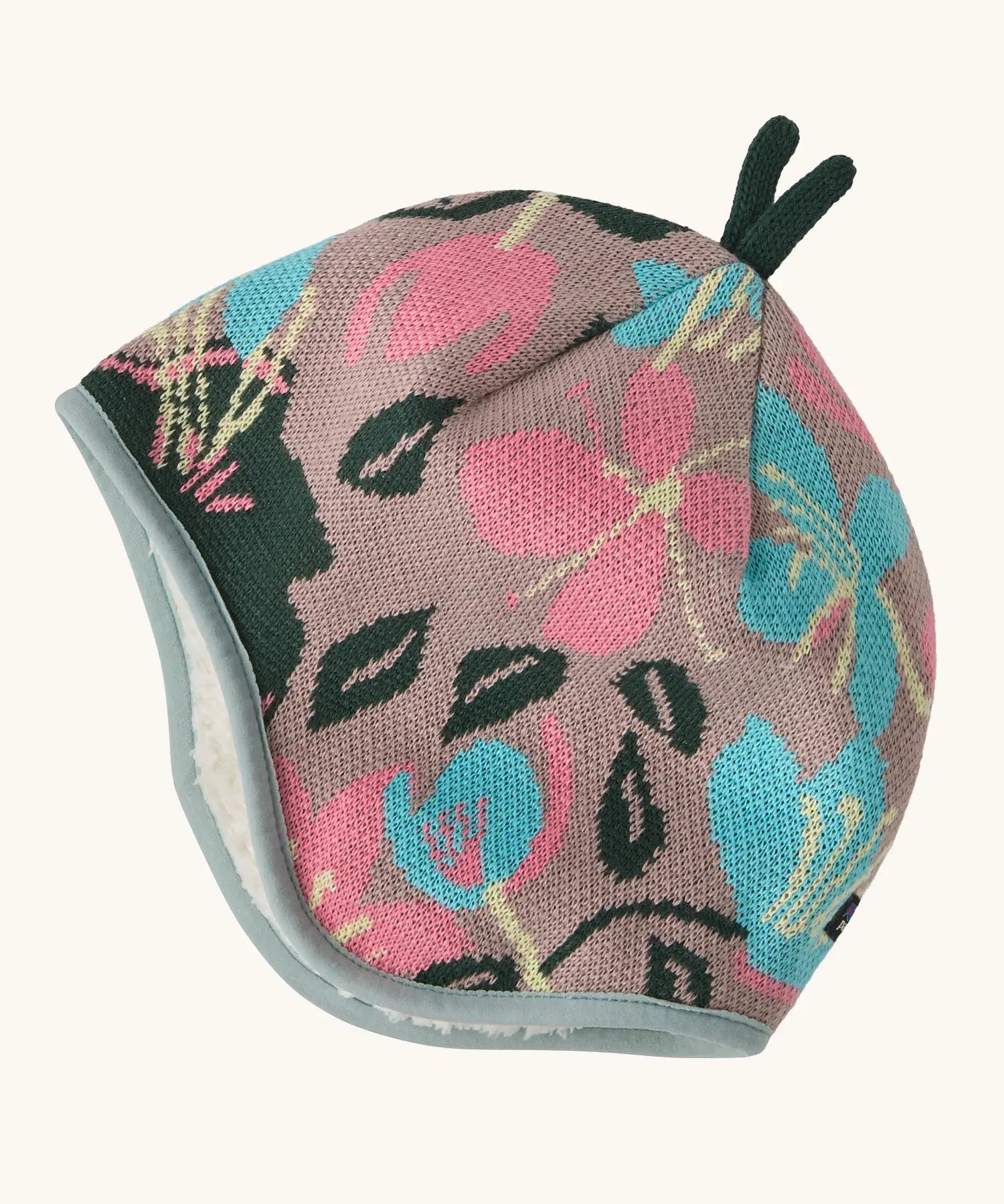 Patagonia baby cosy reversible beanie hat in hope blooms/fuzzy mauve showing a repeating knitted floral design 