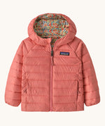 Patagonia little kids down hooded jacket in tiny world/lichen green available at Babipur. A pink warm reversible jacket with a cute floral on the reversible side. Features a a full length zip and 2 side pockets.