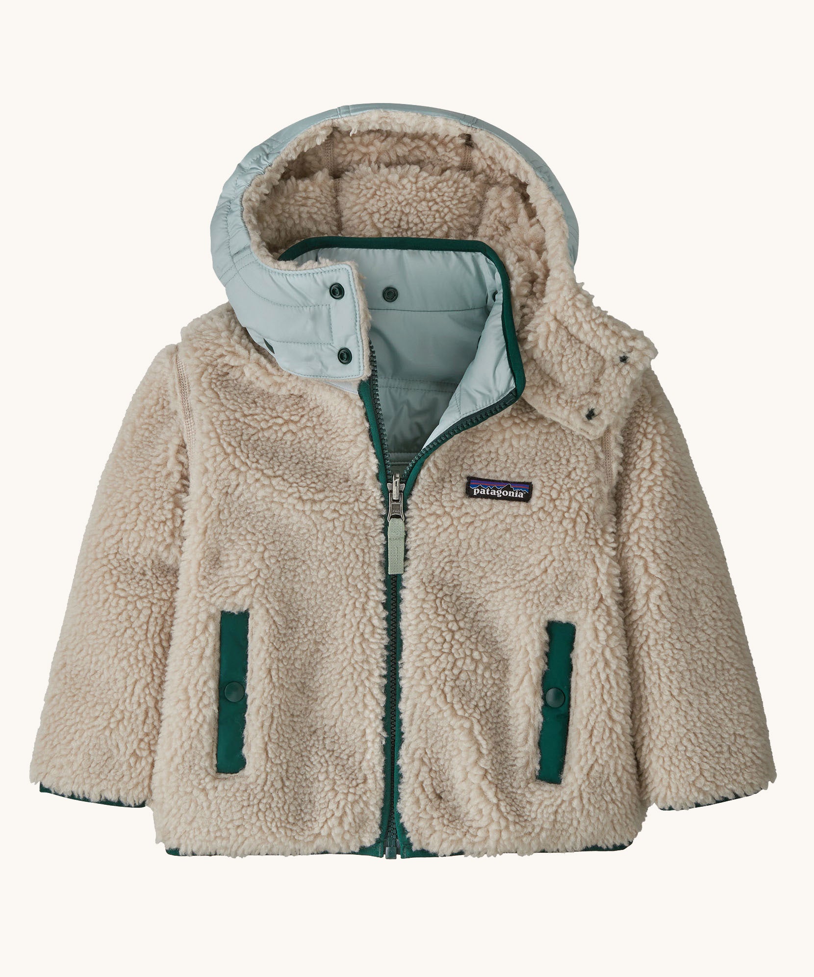 Patagonia little kids tribbles hoody. Showing the natural fleece alternative side. Features a full length zip, a logo patch on the chest and 2 side pockets 