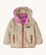 Patagonia little kids tribbles hoody. Showing the natural fleece alternative side with pale red trim. Features a full length zip, a logo patch on the chest and 2 side pockets 