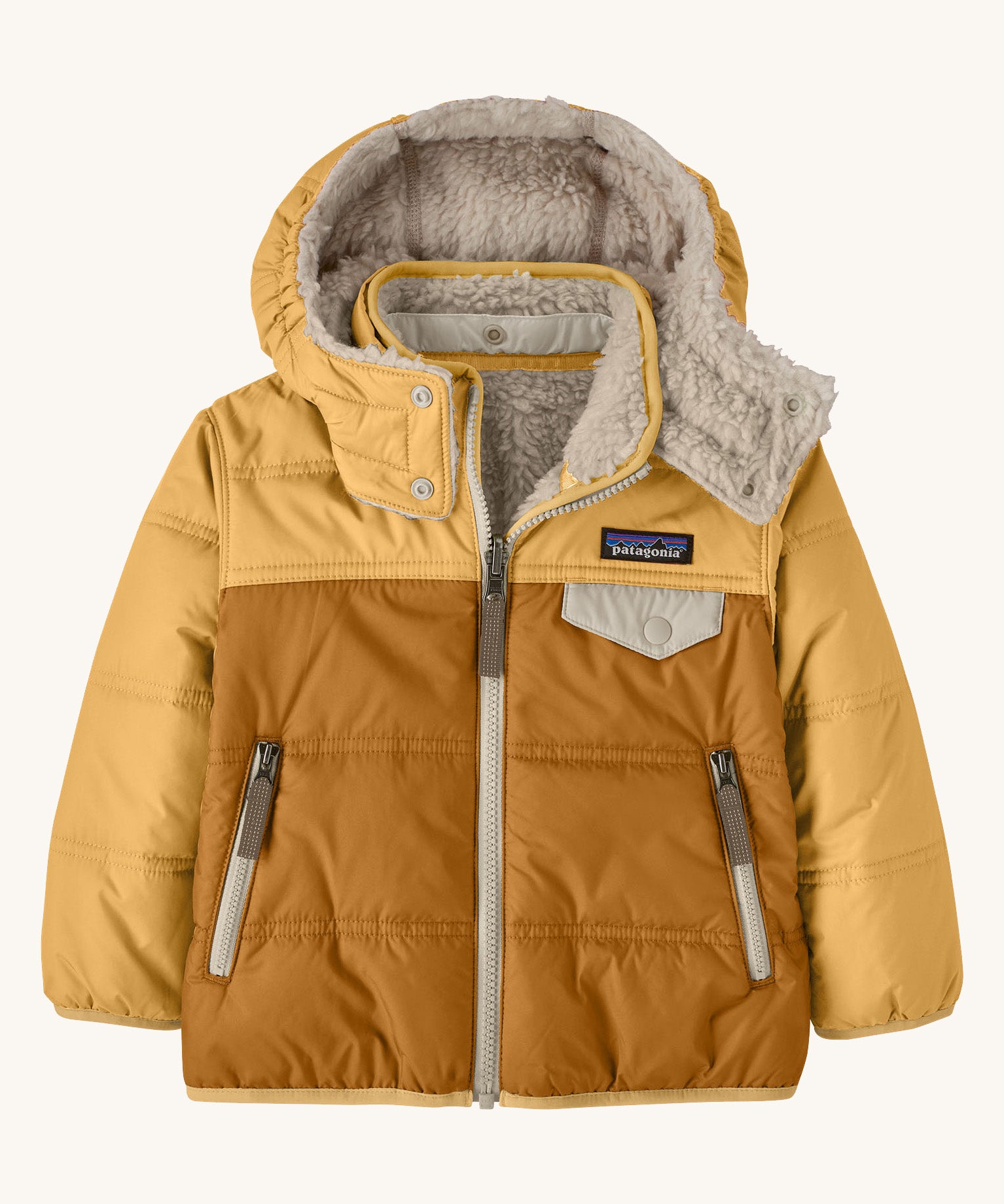 Patagonia little kids tribbles hoody available at Babipur. A reversible coat showing a dark and light yellow hooded coat and natural fleece inner for warmth. Features a small chest pocket with popper fastening and 2 side zip pockets