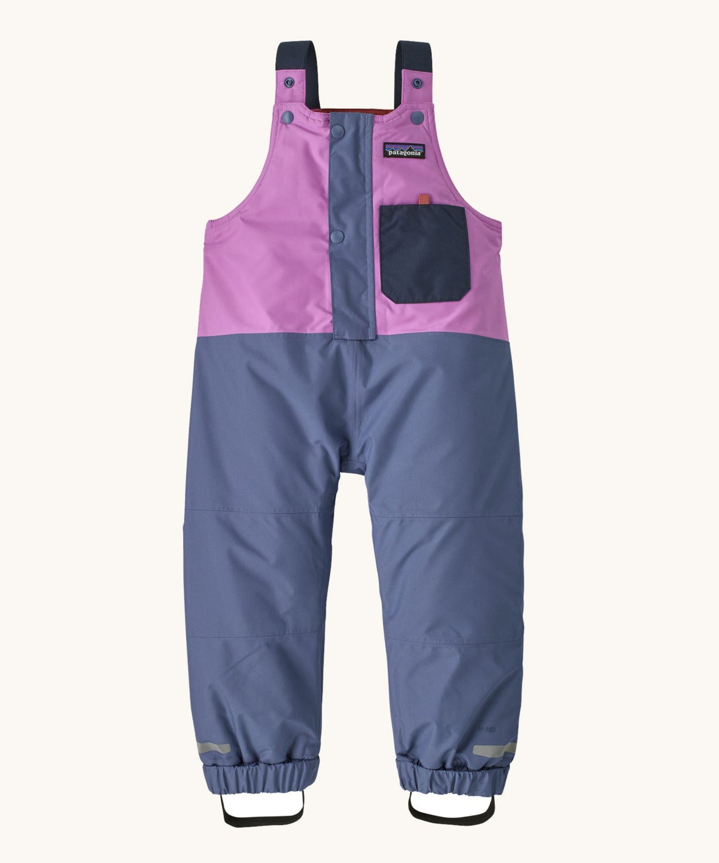 The Patagonia Baby Snow Pile Bibs in a  brisk purple available at Babipur. A 100% recycled polyester winter dungaree in bright purple and pale blue. Features popper fastener, small front pocket and elasticated cuffs and band for a secure fit