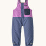 The Patagonia Baby Snow Pile Bibs in a  brisk purple available at Babipur. A 100% recycled polyester winter dungaree in bright purple and pale blue. Features popper fastener, small front pocket and elasticated cuffs and band for a secure fit