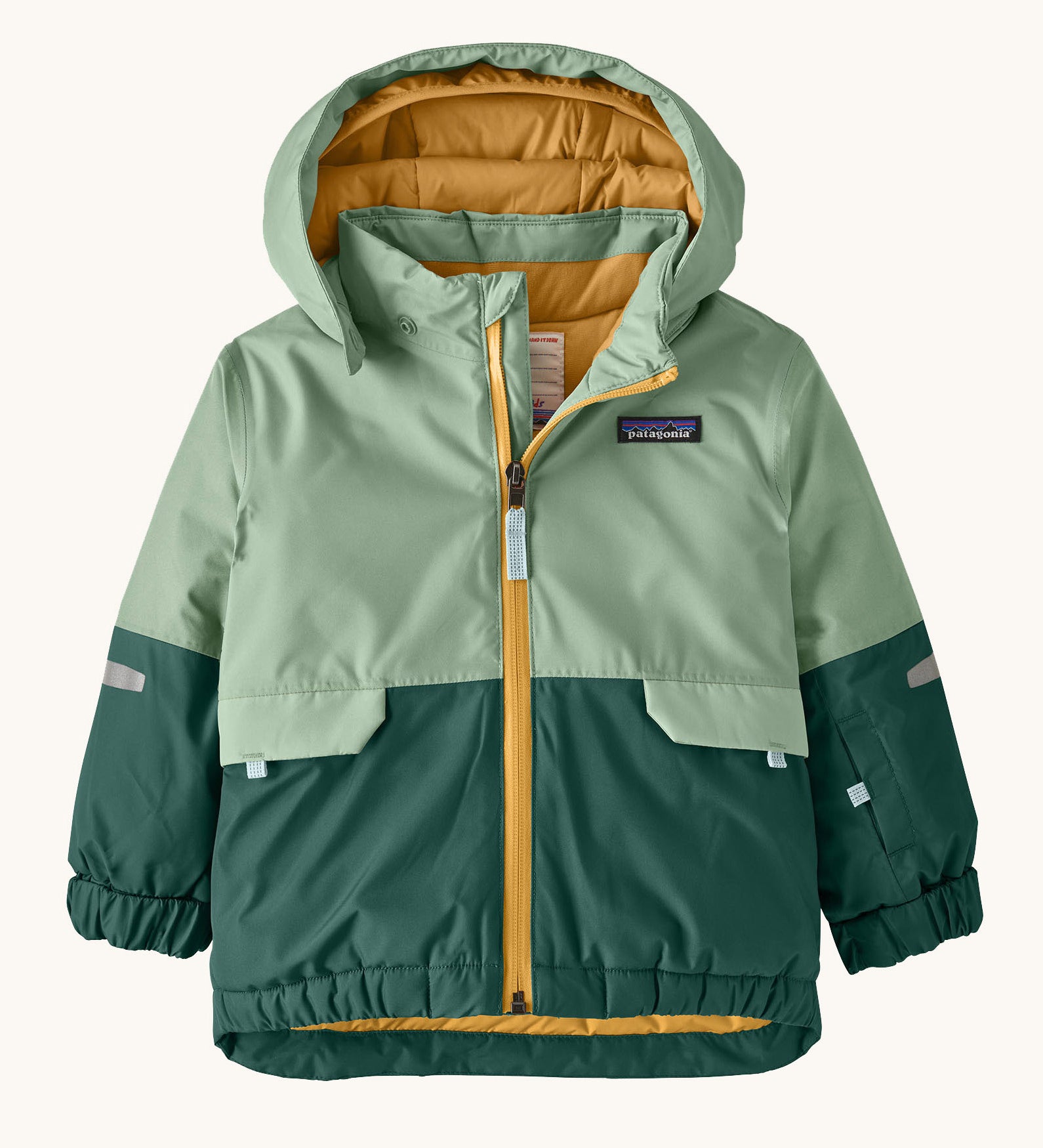 Patagonia little kids snow pile jacket in ellwood green available at Babipur. A 100% recycled polyester thick winter hooded jacket in light and dark green. Features a full length zip, side pocket and elasticated cuffs.