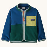 Patagonia little kids synchilla fleece in clement blue available at Babipur. A 100% recycled polyester soft fleece jacket in dark blue and green with pale blue trim. Features a full length zip and a yellow chest pocket