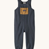 Patagonia little kids synchilla fleece dungarees in smolder blue available at Babipur. A 100% recycled polyester soft fleece dungarees in dark blue with a small front pocket in brown. Features popper fasteners and elasticated leg cuffs
