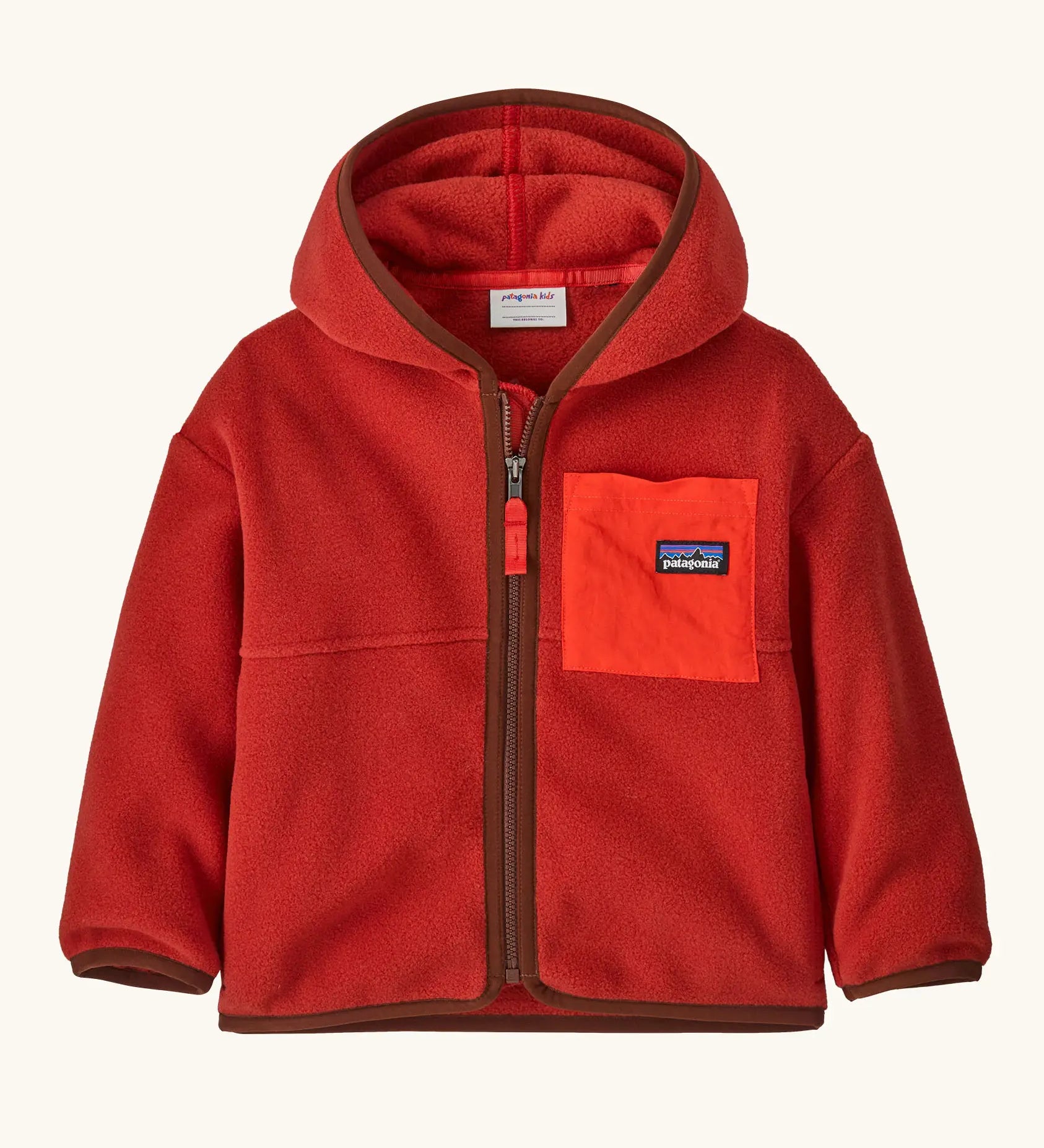 Patagonia little kids synchilla hoody in Amanita red. 100% recycled polyester hooded jacket in red with contrasting trim and pocket. Features a full length zip and a chest pocket. 