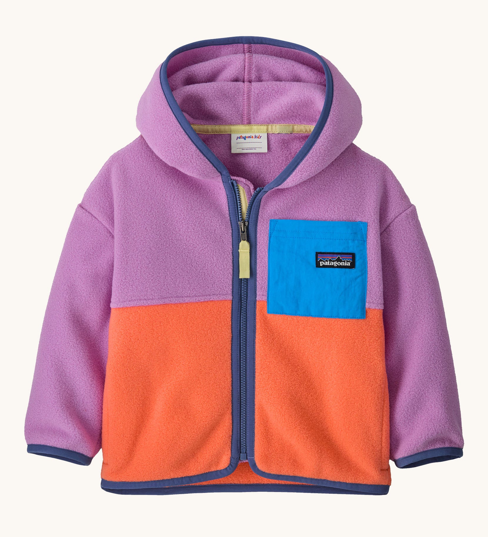 Patagonia little kids synchilla hoody in brisk purple available at Babipur. A 100% recycled polyester hooded jacket in purple and orange with dark purple trim. Features a full length zip and a blue chest pocket. 