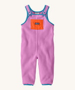 Patagonia little kids synchilla fleece dungarees in brisk purple available at Babipur. A 100% recycled polyester soft fleece dungarees in bright purple with blue trim. Features a small front pocket in orange, elasticated leg cuffs and popper fasteners on the shoulder straps