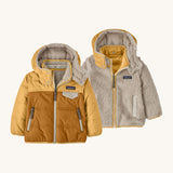 Patagonia little kids tribbles hoody. A reversible coat showing a dark and light yellow hooded coat and natural fleece alternative side. Features a small chest pocket and side pockets