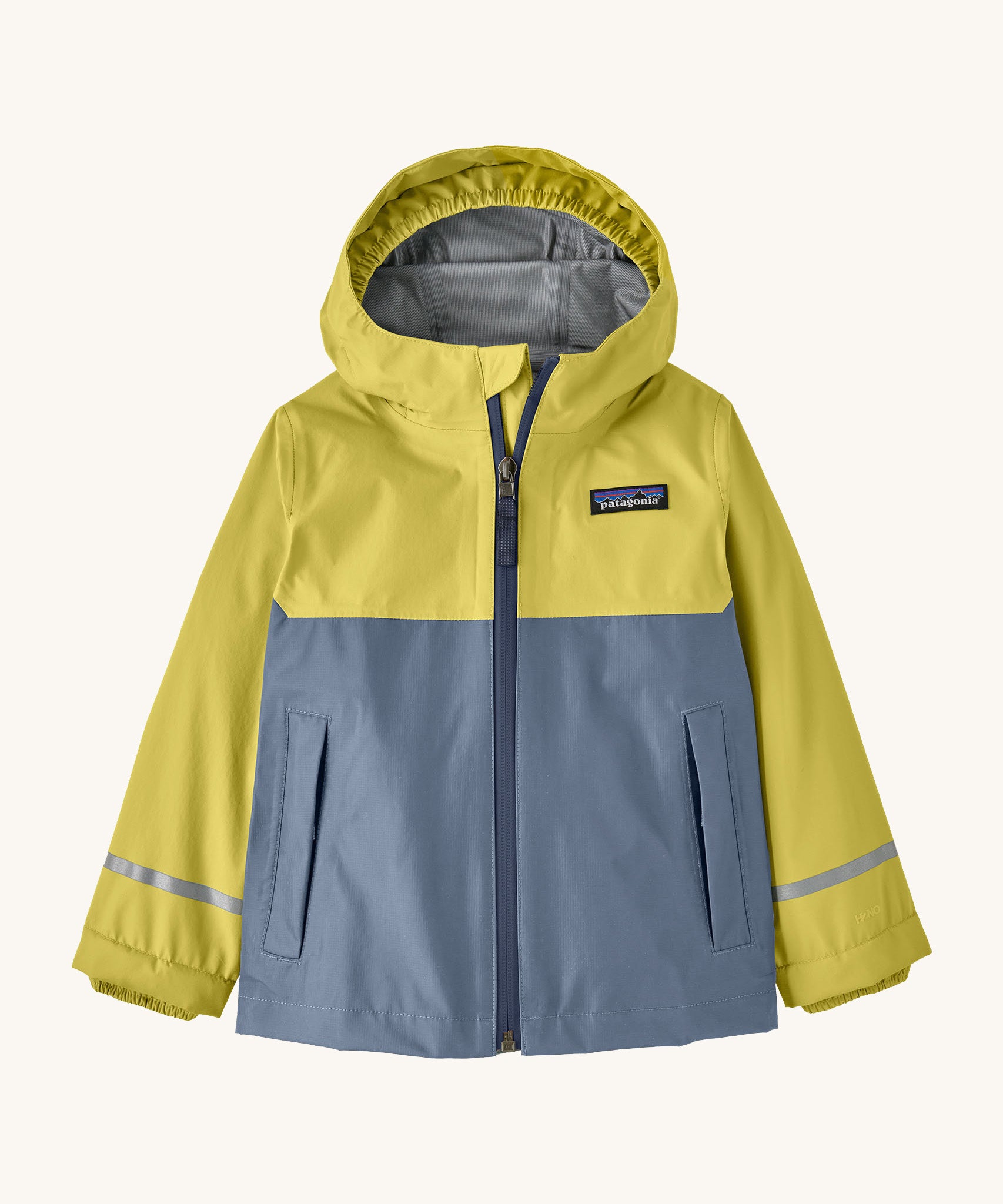 The Patagonia Little Kids Torrentshell 3L Waterproof Jacket in nearly green available at Babipur. A waterproof jacket in a yellow/grey and grey colourblock design. Features a full length zip, a hood with a elasticated cuff, 2 side pockets and a reflective strip on the cuffs