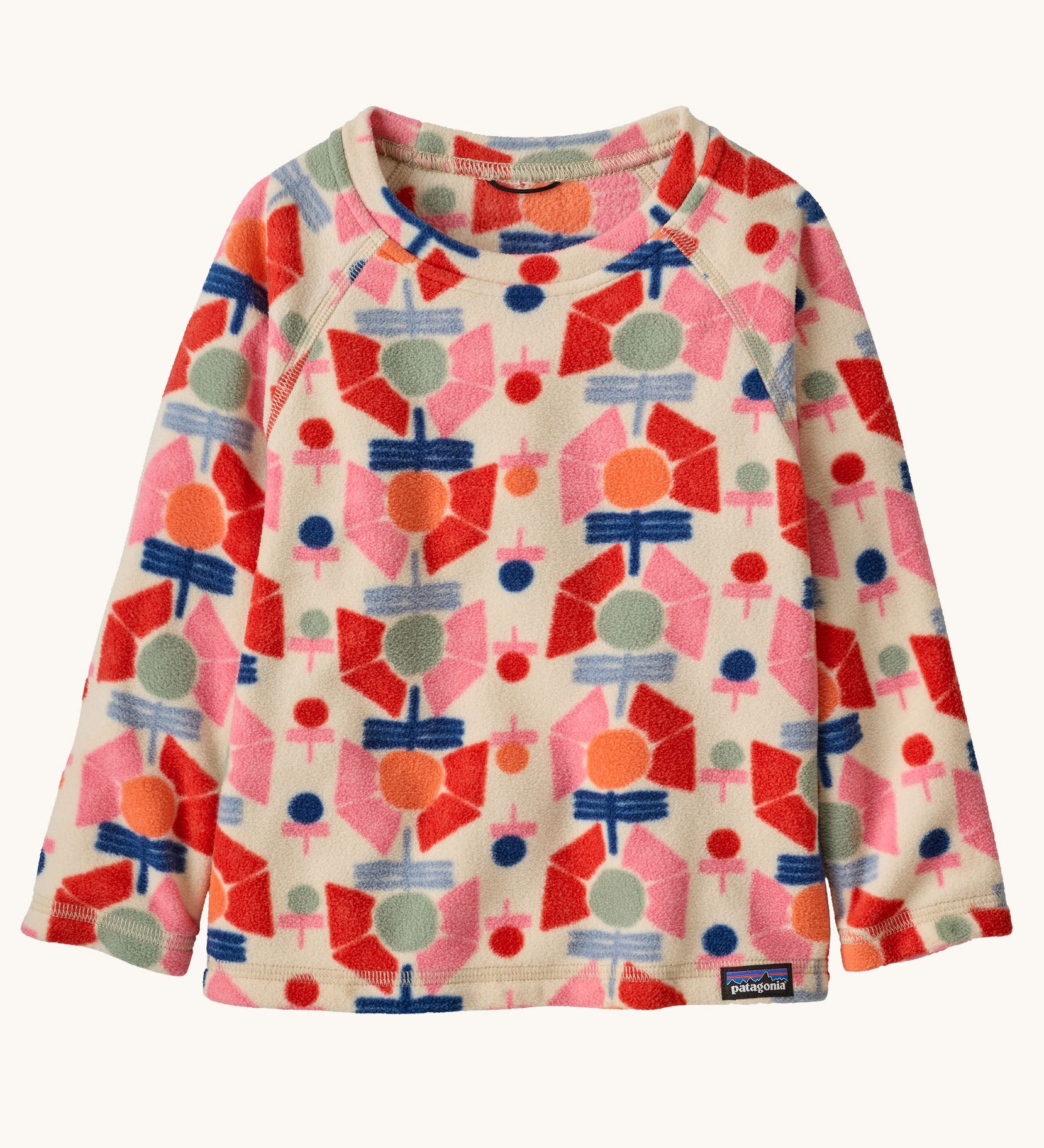 Patagonia kittle kids micro d crew jumper in stamped floral/natural available at Babipur. A 100% recycled polyester soft fleece jumper in cream with a retro multicoloured flower pattern design 