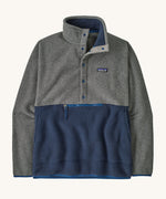 Patagonia Men's fleece pullover in grey and dark blue lower body. Features a 3/4 length front popper and a zipped pouch pocket .
