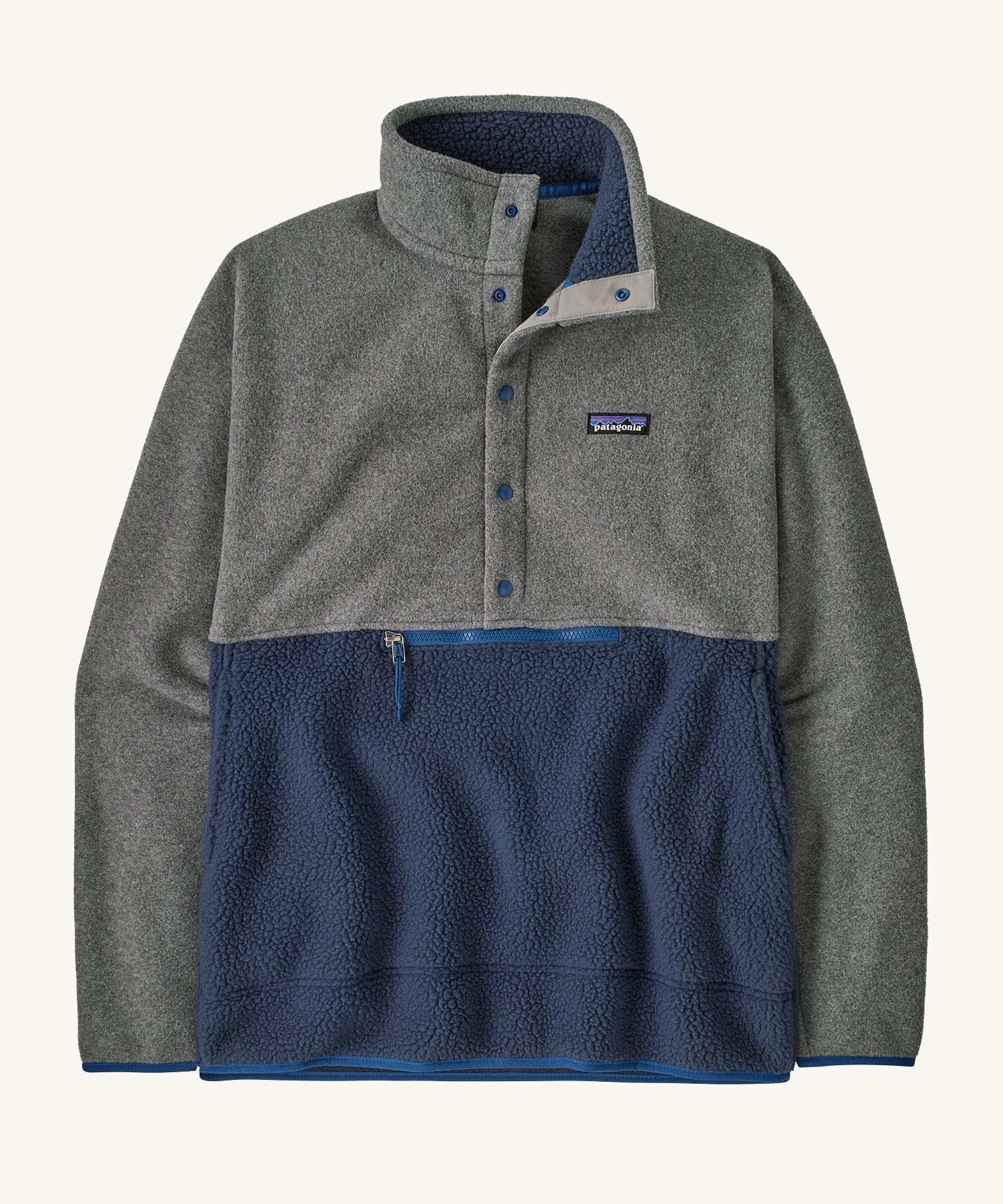 Patagonia Men's fleece pullover in grey and dark blue lower body. Features a 3/4 length front popper and a zipped pouch pocket .