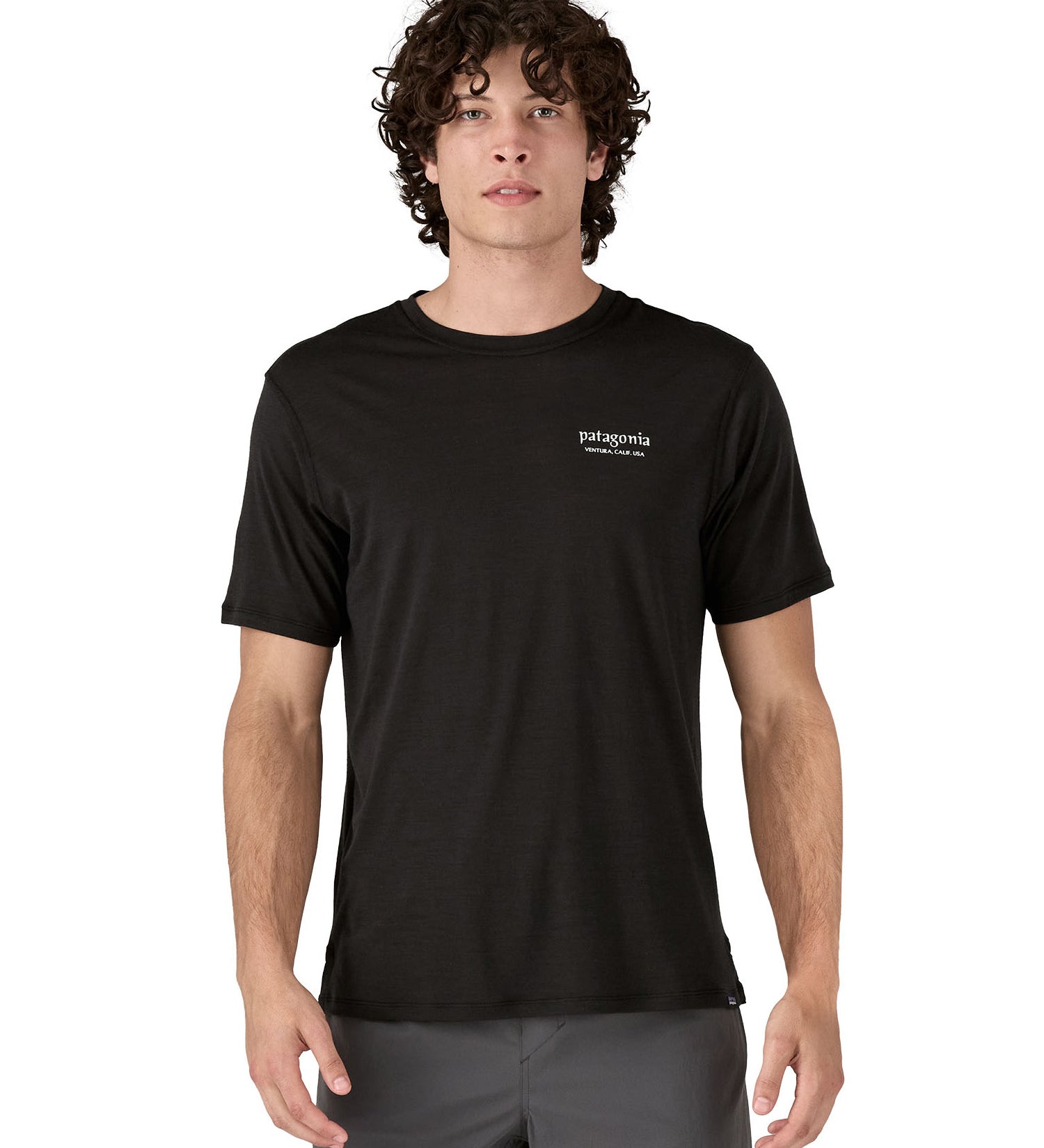 A man wearing the Patagonia Men's Capilene Cool Merino Graphic Shirt with a Heritage Header design in Black available at Babipur showing the front fit