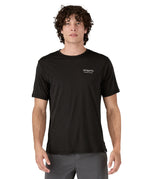 A man wearing the Patagonia Men's Capilene Cool Merino Graphic Shirt with a Heritage Header design in Black available at Babipur showing the front fit