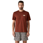 A man wearing the Patagonia Men's 73 Skyline Organic T-Shirt available at Babipur.