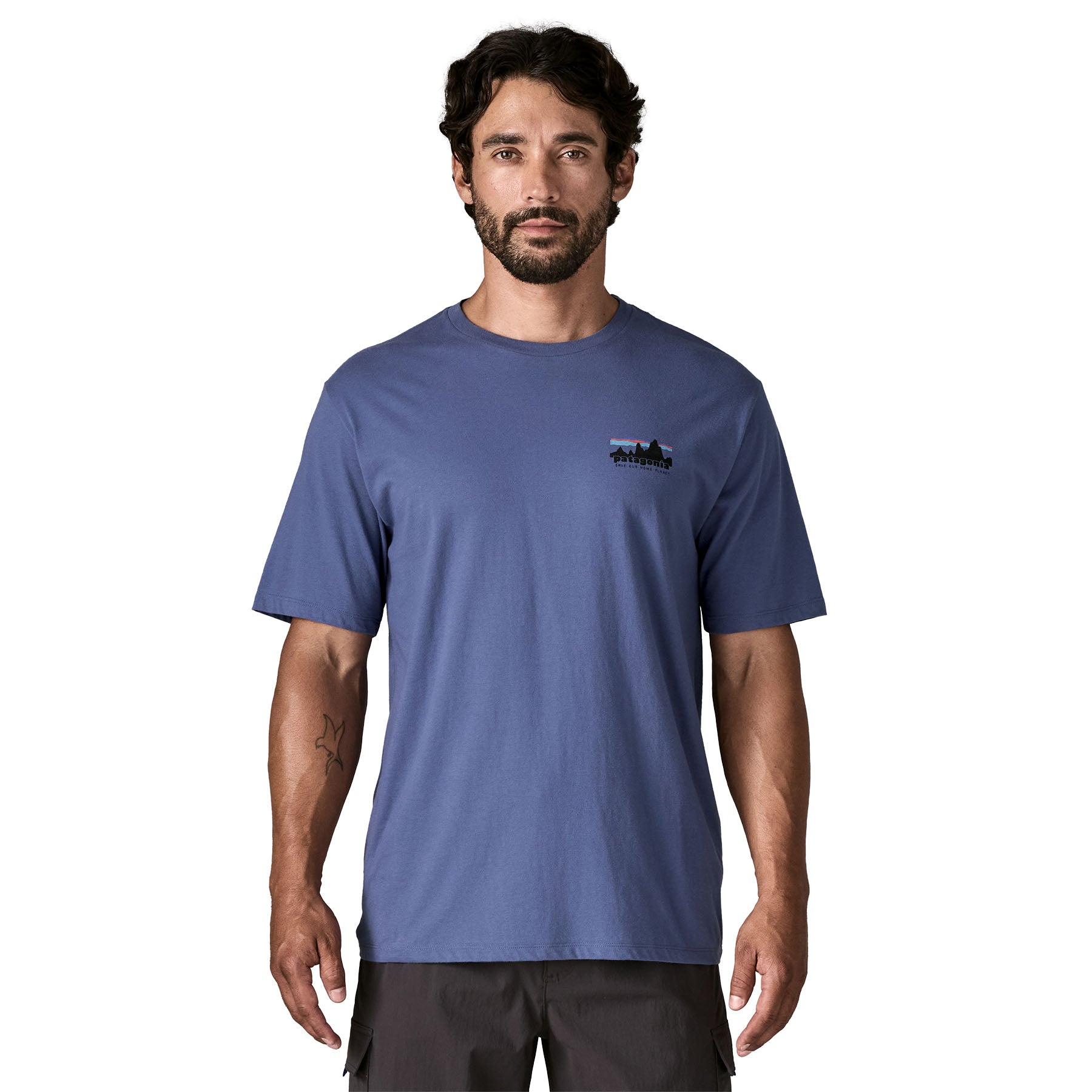 A man wearing the Patagonia Men's 73 Skyline Organic T-Shirt in current blue available at Babipur.