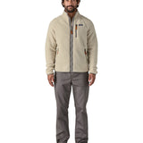 A man wearing the Patagonia Men's Retro Pile Fleece Jacket in a Pelican colour available at Babipur. A cream coloured fleece with grey trim. Features a full length zip