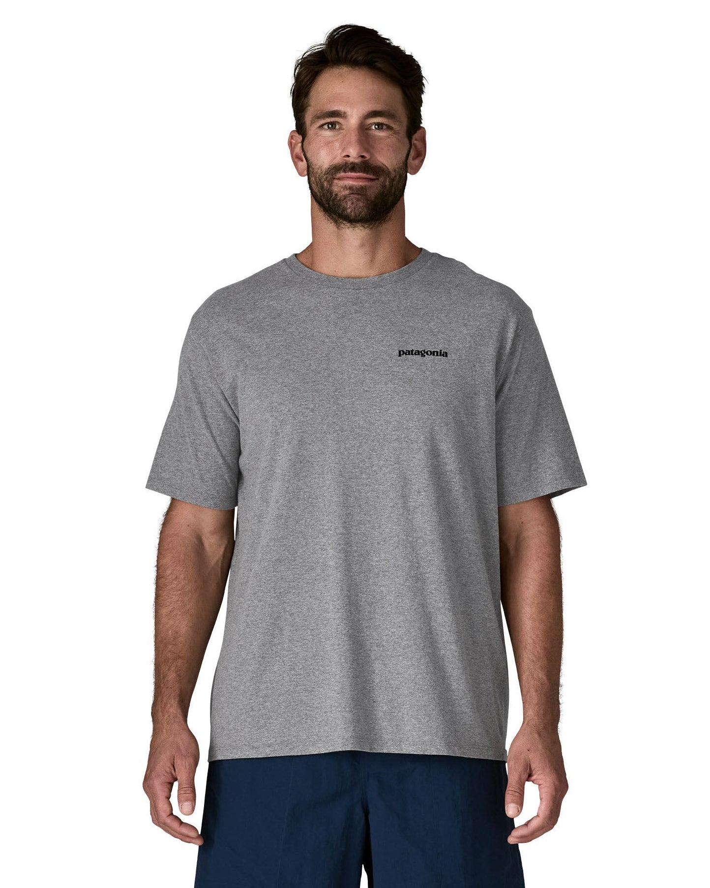 Man wearing Patagonia's men's responsibili t-shirt in grey with brand text on chest. T-shirt has a relaxed fit