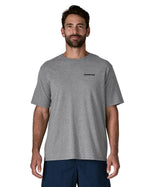 Man wearing Patagonia's men's responsibili t-shirt in grey with brand text on chest. T-shirt has a relaxed fit