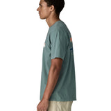 Side of man wearing Patagonia's 100% organic cotton 73 skyline t-shirt in light blue. T-shirt has relaxed fit 