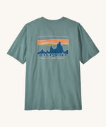 Patagonia men's 100% organic cotton 73 skyline t-shirt in pastel blue with a mountain range logo on the upper back
