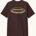 Patagonia men's 95 oval logo short sleeve t-shirt in den brown. Shows large oval brand patch on upper back