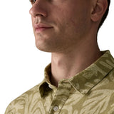 Collar of Patagonia men's buttoned short sleeve shirt in light green with a repeating abstract design