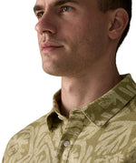 Collar of Patagonia men's buttoned short sleeve shirt in light green with a repeating abstract design