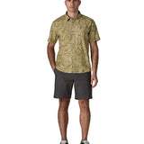 Man wearing Patagonia men's buttoned short sleeve shirt in light green with a repeating abstract pattern design. 