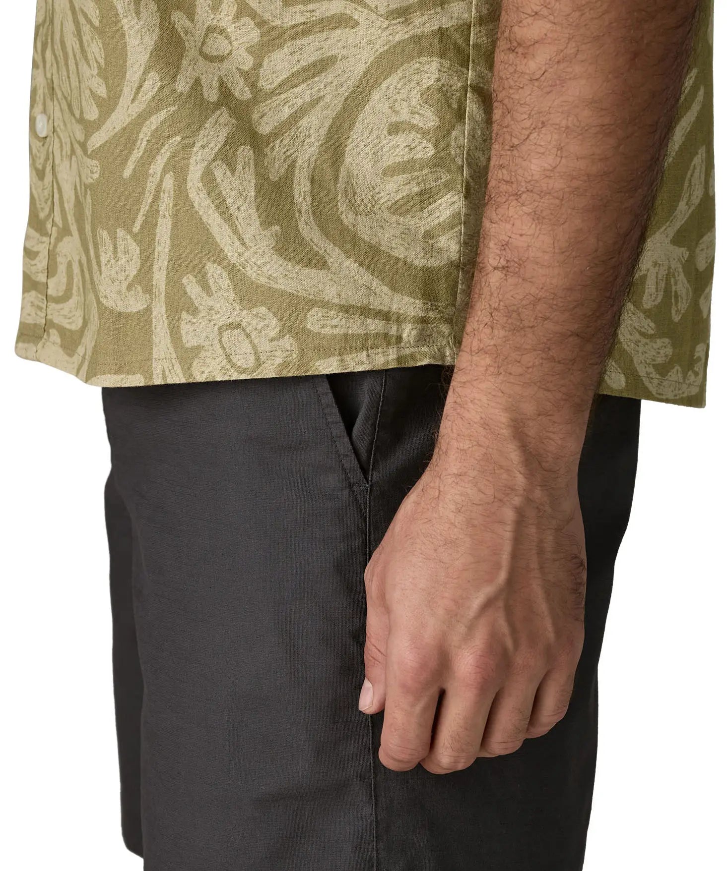 Hem of Patagonia men's buttoned short sleeve shirt in light green with a repeating abstract pattern design 