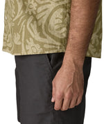 Hem of Patagonia men's buttoned short sleeve shirt in light green with a repeating abstract pattern design 
